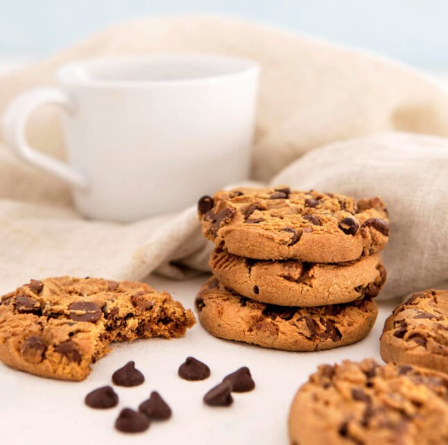 Chocolate cookies chips behind cup
